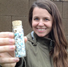 Carolynn Box holds a vial with a small sample of the millions of plastic fragments floating in each of the world's oceans.