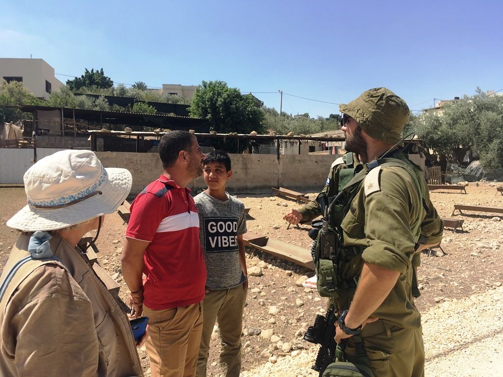 Observing Soldiers confronting Palestinians sized